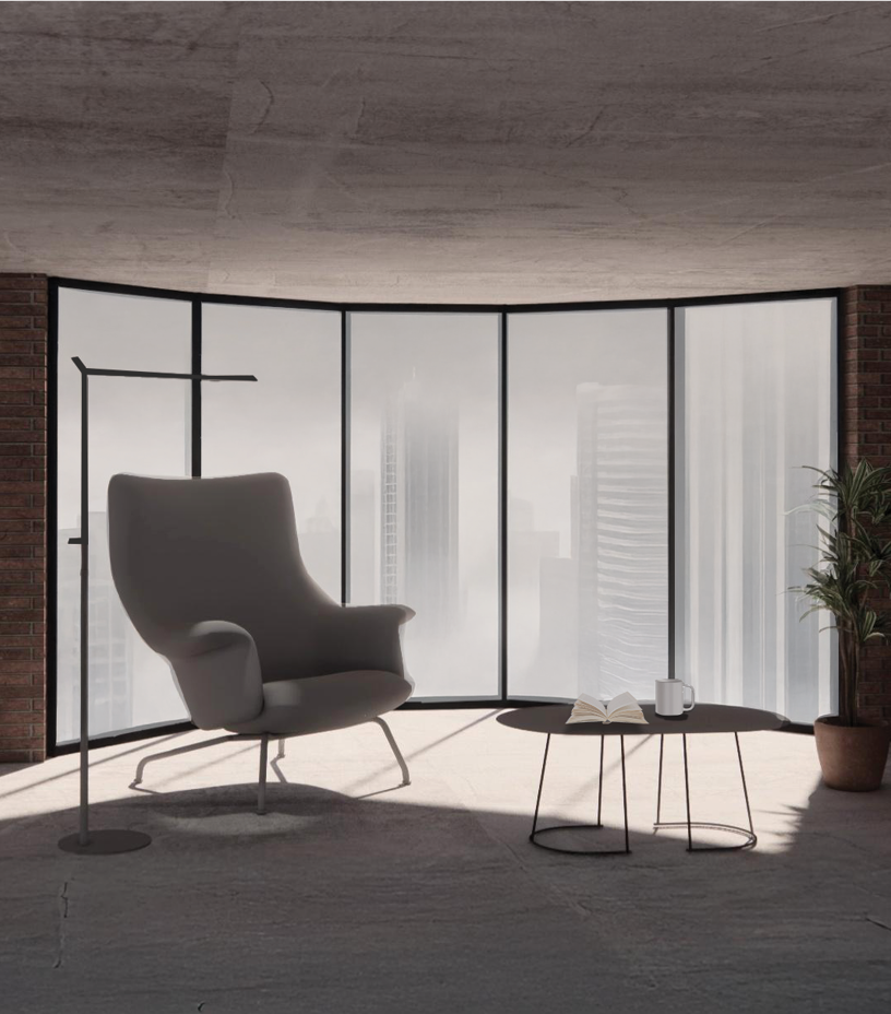Rendered living room with a curved wall of floor-to-ceiling windows onto a foggy skyline, a gray lounge chair and a round side table